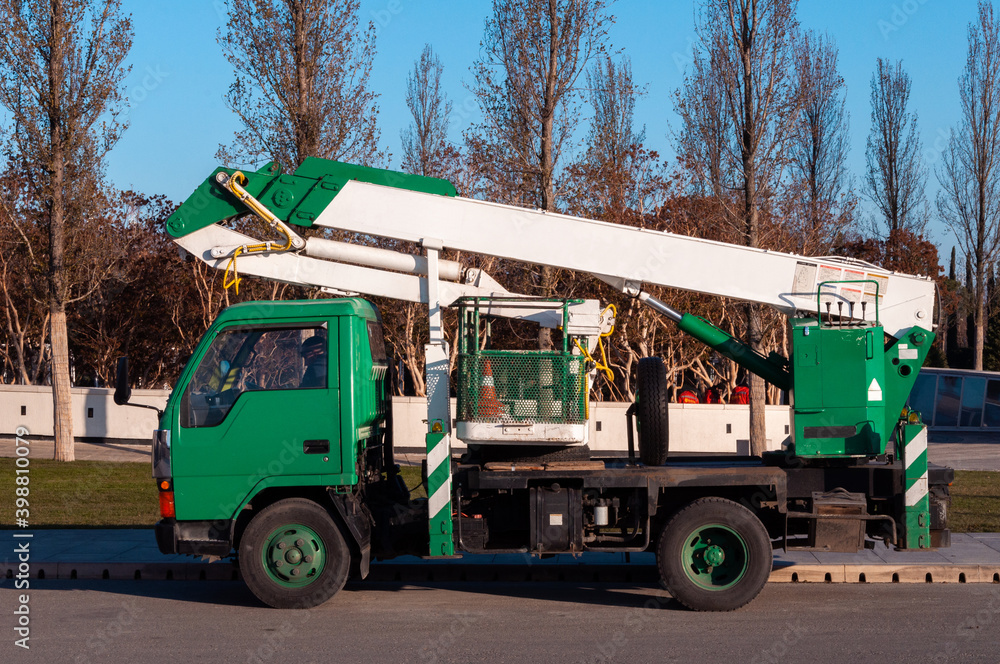 Krasnodar, Russia - December 10 2020: Pruning service truck in Krasnodar, vehicle with crane basket for pruning trees
