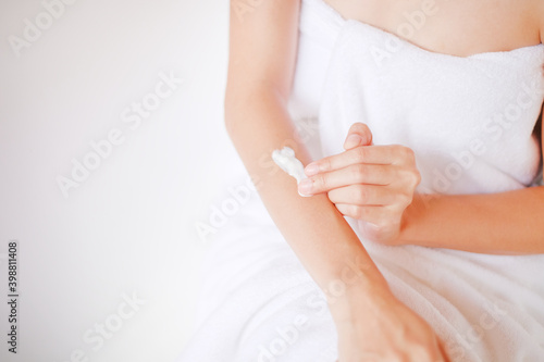 Woman applying cream lotion on hand with white background  Beauty concept. Top view