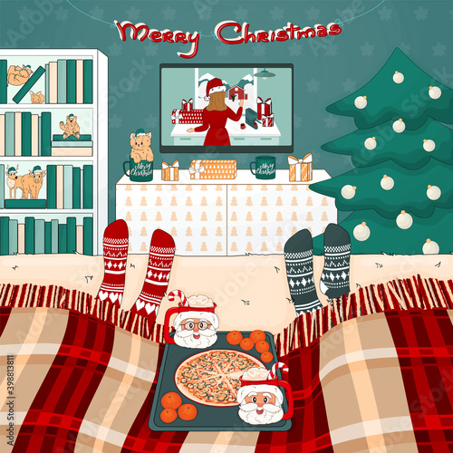Christmas pizza, cocoa with marshmallows, TV set, bookcase, tree, bed with plaid, toys, gifts are in the room. Two people are watching movies under the plaid in knitted socks