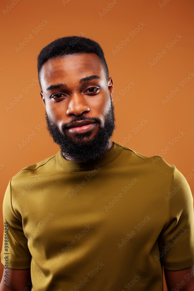 Fototapeta premium young pretty african american man posing cheerful on brown background, lifestyle people concept