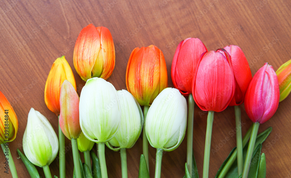 Bouquet of tulips on a wooden background with leaves. copy space area Bouquet of tulips on a wooden background with leaves. copy space area