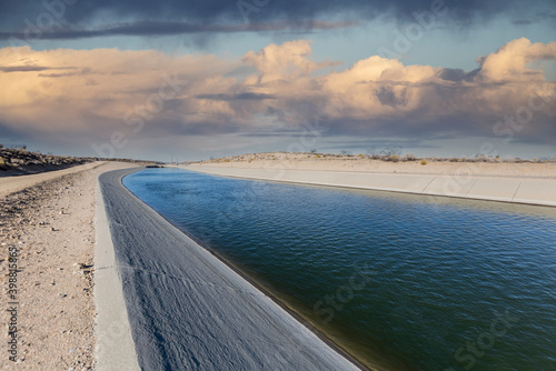 Fotografiet California aqueduct with storm sky in the Mojave desert area of northern Los Angeles County