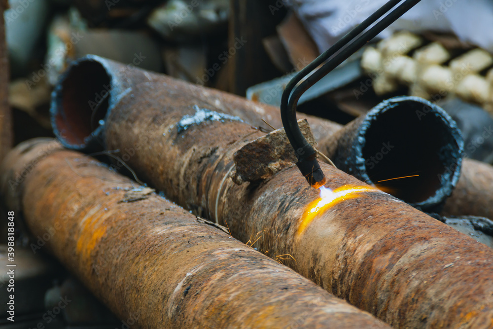 Scrap yard, cutting used pipes with gas equipment, metal for recycling. Scrap yard, cutting used pipes with gas equipment, metal for recycling.