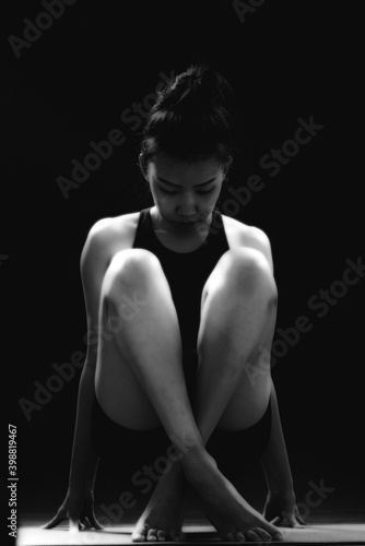 Low key portrait, rimlight portrait woman yoga on black background. © TinPong