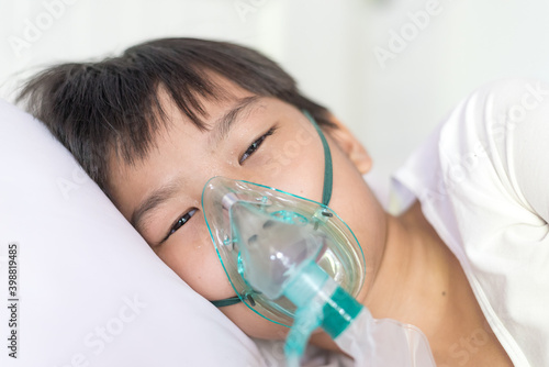 Young asian boy with face oygen mask photo