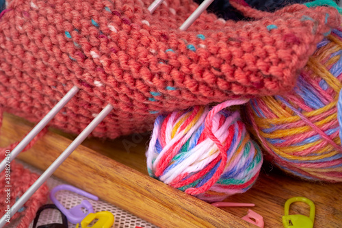 Multi-colored wool for knitting. Knitting needles.