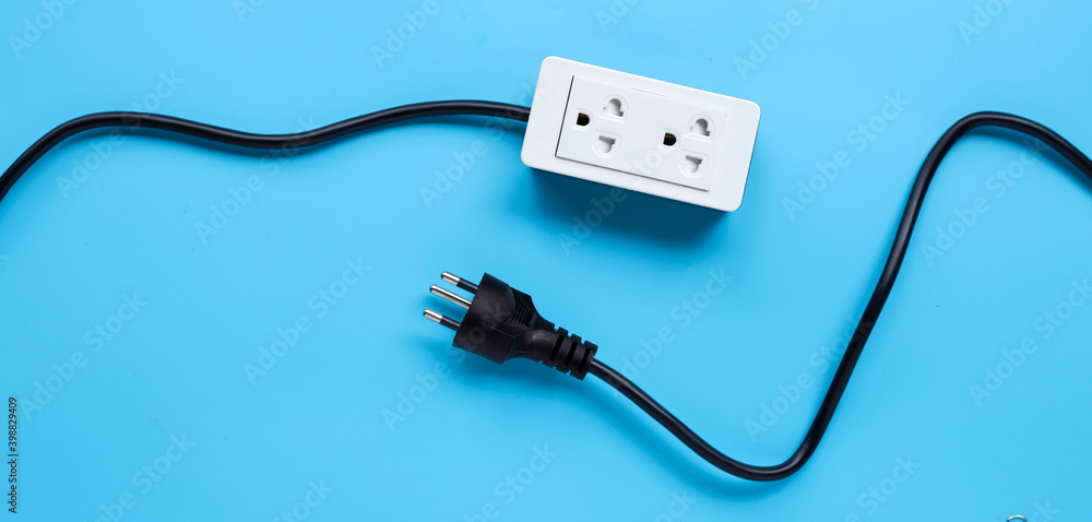 Electrical power strip and plug on blue background. Top view Electrical power strip and plug on blue background. Top view