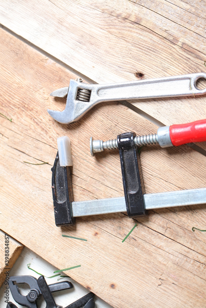 carpenter's tools lie on a wooden table clamp plane carpenter's tools lie on a wooden table clamp plane