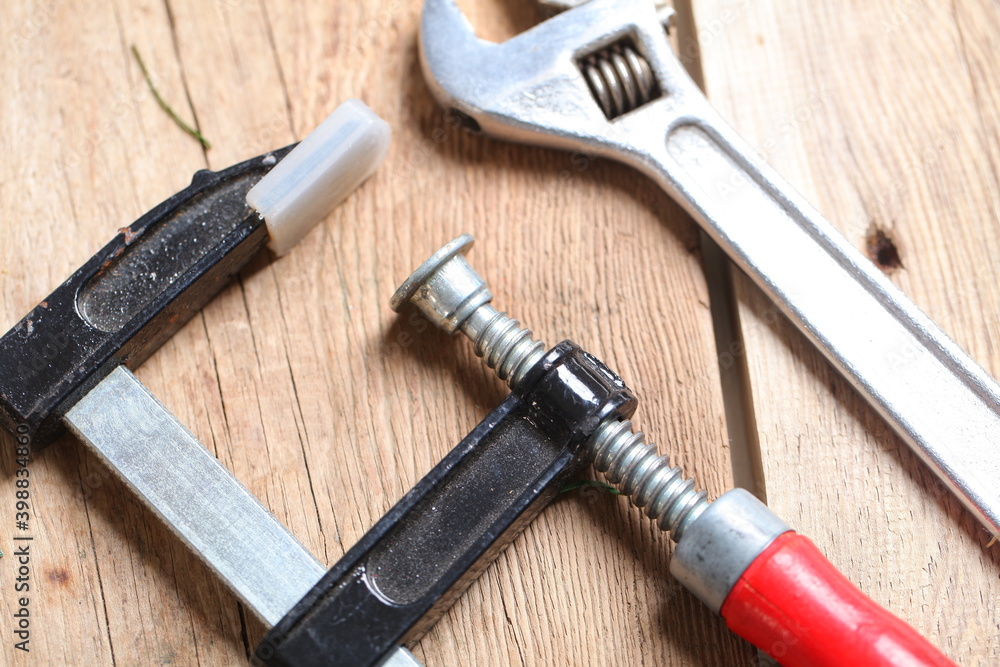 carpenter's tools lie on a wooden table clamp plane carpenter's tools lie on a wooden table clamp plane