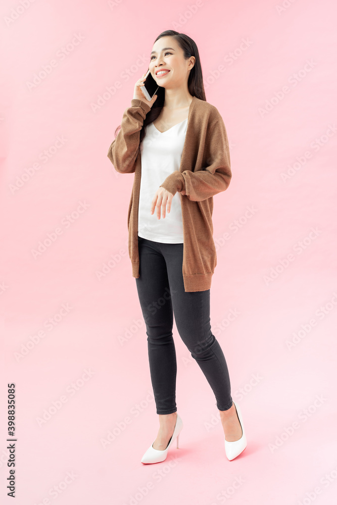 Side portrait of a smiling young woman walking with mobile phone Side portrait of a smiling young woman walking with mobile phone