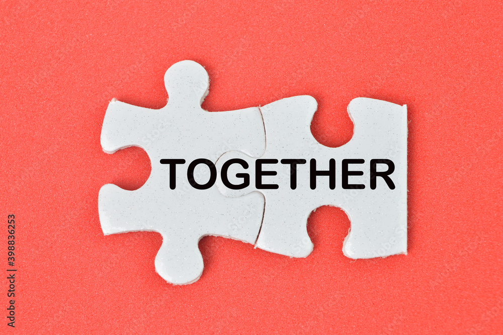 Together word on two pieces of jigsaw puzzle. Business and education concept. Together word on two pieces of jigsaw puzzle. Business and education concept.