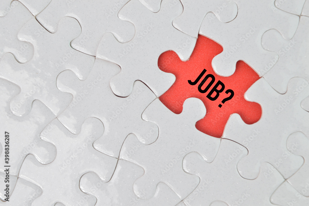 Fototapeta premium Top view of jigsaw puzzle with word JOB?. Business concept. 