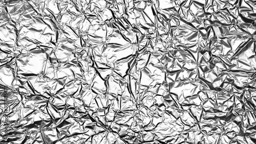 Crumpled foil sheet background texture , silver aluminum foil as background for design © MARIIA