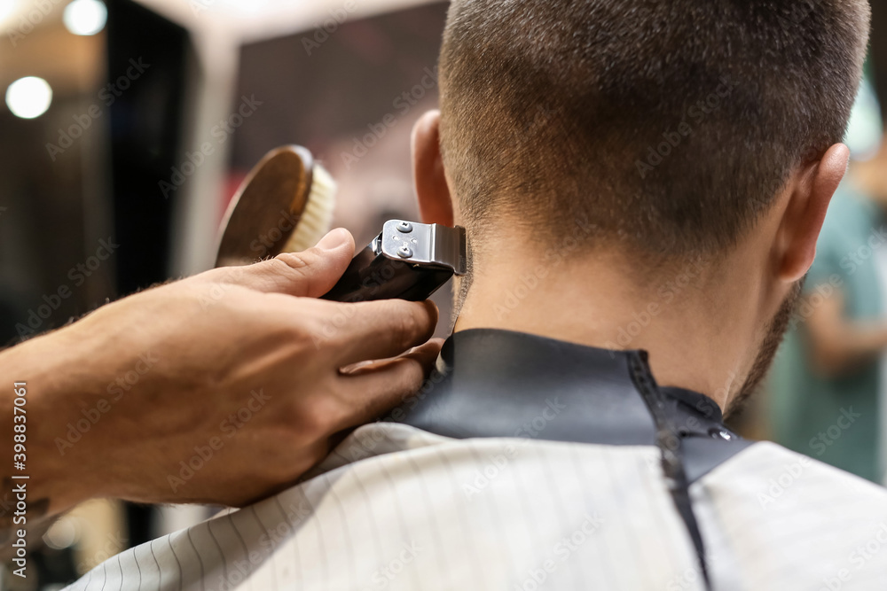 Professional hairdresser working with client in barbershop Professional hairdresser working with client in barbershop