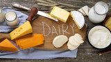 Different types of fresh dairy products on wooden background