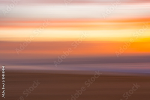 Golden sunset on the beach  an  abstract seascape with blurred panning motion in soft colors