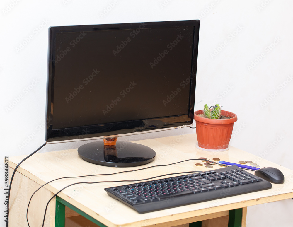 Fototapeta premium Computer on the table with a cactus
