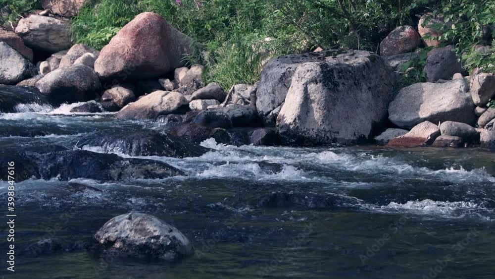 Beautiful mountain stream. With water beating among gray stones. Mountain river runs in rocks Beautiful mountain stream. With water beating among gray stones. Mountain river runs in rocks