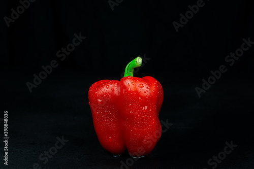 natural red pepper on black background