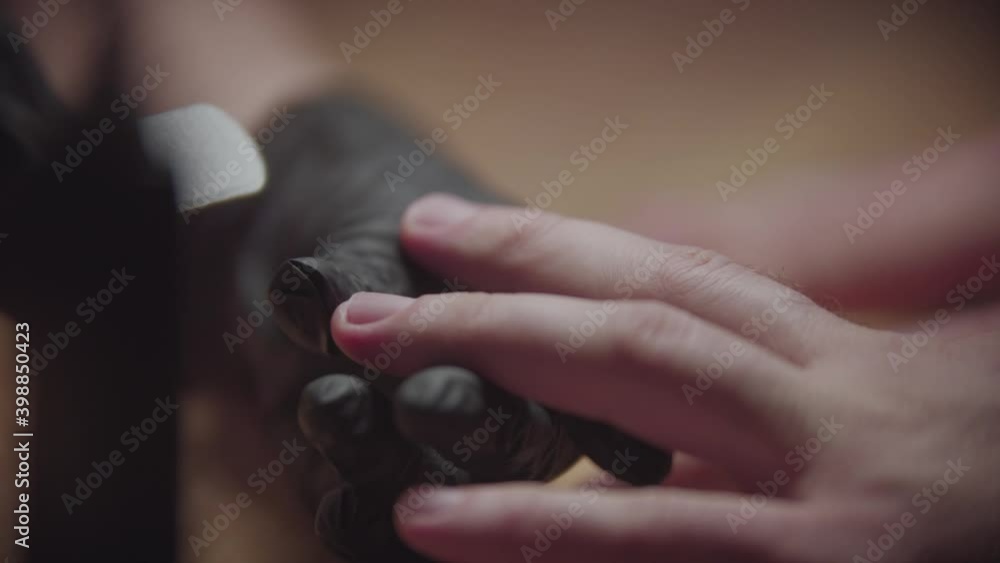 Male hardware manicure - the nail master preparing the nail for the design - buffing the free edge of nail Male hardware manicure - the nail master preparing the nail for the design - buffing the free edge of nail