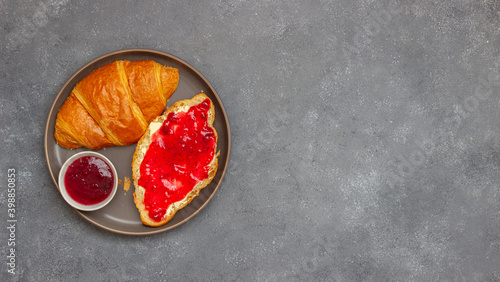 Croissant with cranberry jam and butter. Breakfast. Vegetarian food. Pastries.
