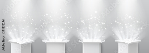Open surprise gift box with magic light and spotlights lighting from above.