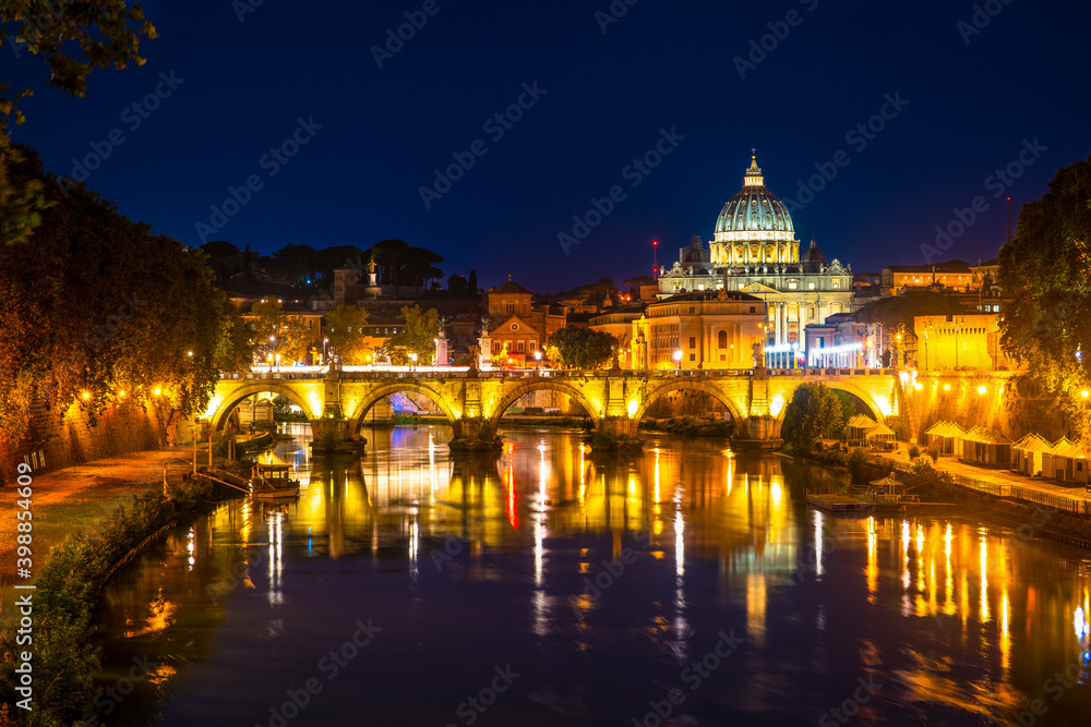 Sant' Angelo Bridge and St. Peter's cathedral at night in Vatican City, Rome.Italy