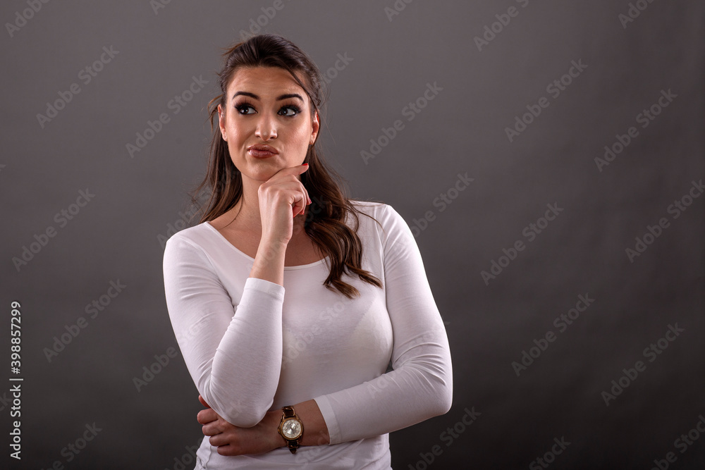 Portrait of beautiful young woman thinking on future on gray background Portrait of beautiful young woman thinking on future on gray background