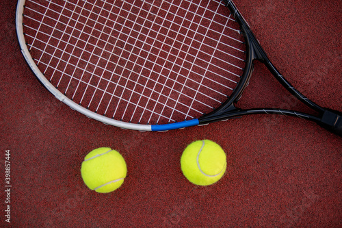 Tennis racket and balls on court © ivanko80