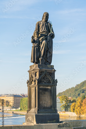 An outdoor statue of St Joseph with a young Christ on Charles Bridge  Prague