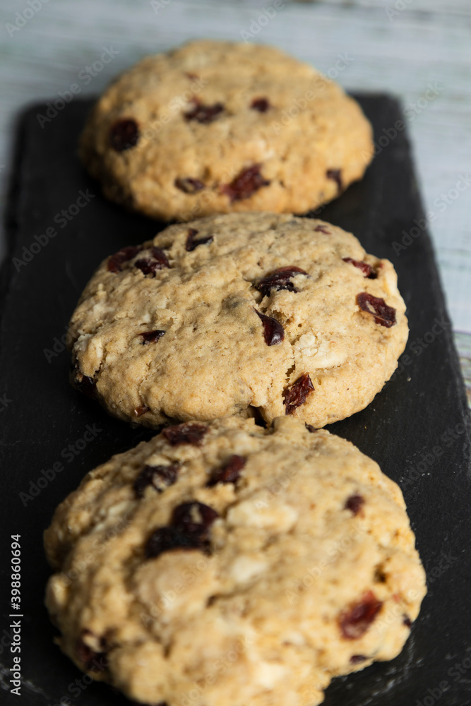 Homemade oatmeal and blueberry cookies on white wood - healthy food and snacks Homemade oatmeal and blueberry cookies on white wood - healthy food and snacks