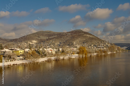 Winter with snow in old downtown, castle and main city bridge in Heidelberg, Germany, with blue cloudy sky and sunny day.
