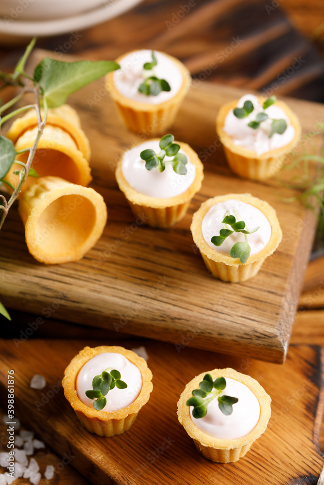 Canapes with light cream filling. Still life with microgreens. The concept of an appetizing snack. Canapes with light cream filling. Still life with microgreens. The concept of an appetizing snack.