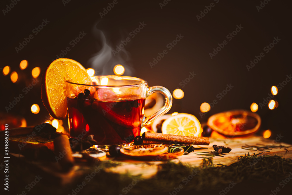 Christmas mulled wine, Drink with dried fruits and berries, Winter hot tea in a glass and spices on a wooden background.	 - obrazy, fototapety, plakaty 