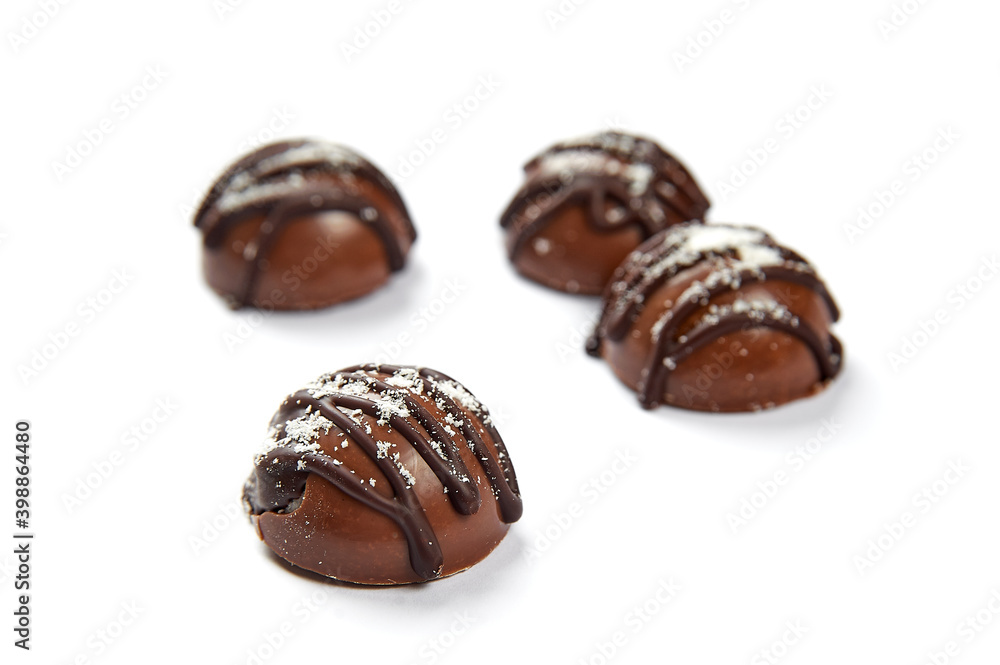 Round sweets with milk chocolate on a white background Round sweets with milk chocolate on a white background
