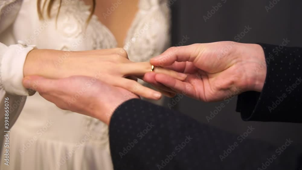 Men putting on wedding ring to the bride finger. Men putting on wedding ring to the bride finger.