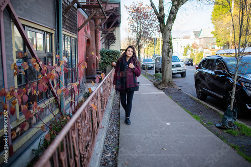 Wallpaper Mural Beautiful woman walking on the sidewalk next to a pink handrail Torontodigital.ca