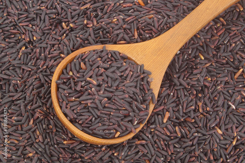 Black rice with wooden spoon