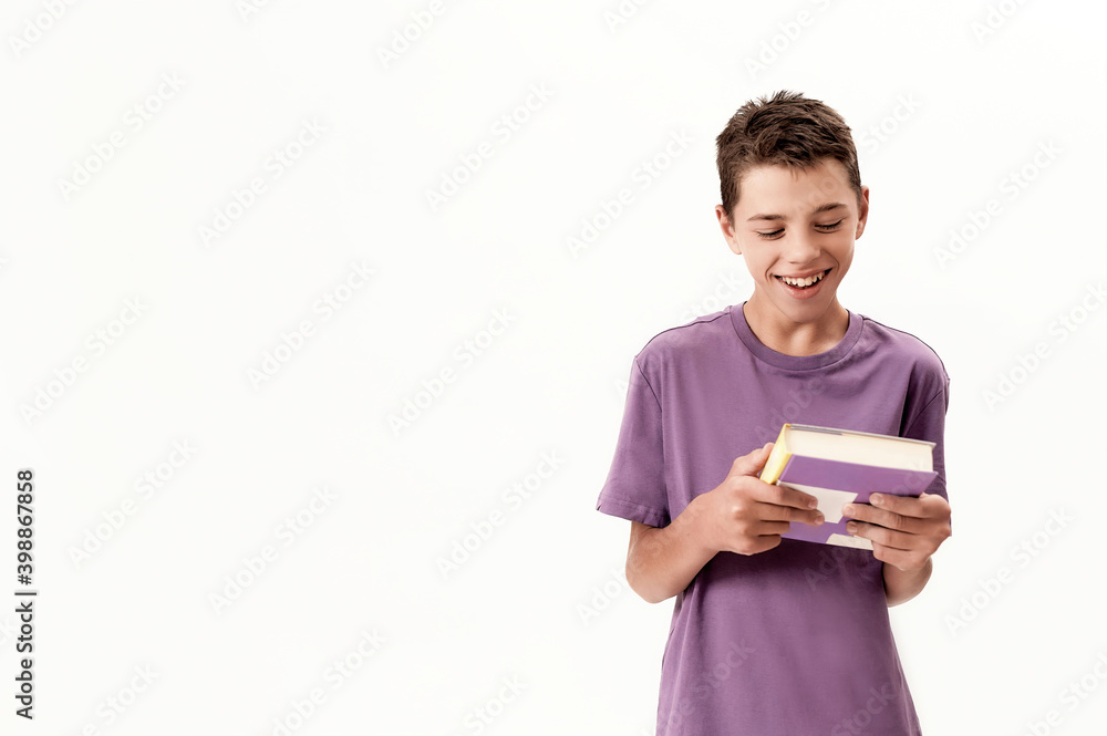 Portrait of teenaged disabled boy with cerebral palsy smiling and holding a book, posing isolated over white background Portrait of teenaged disabled boy with cerebral palsy smiling and holding a book, posing isolated over white background