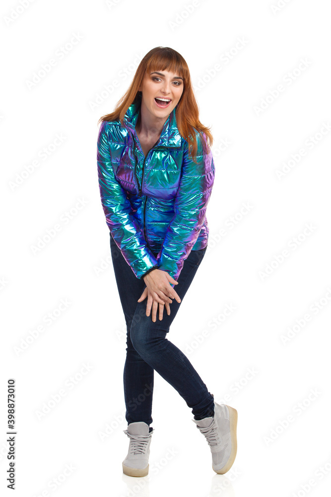 Young Laughing Woman Is Posing In Shiny Vibrant Down Jacket Young Laughing Woman Is Posing In Shiny Vibrant Down Jacket