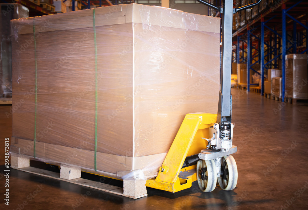 Heavy box on pallet rack with hand pallet truck at the warehouse ...