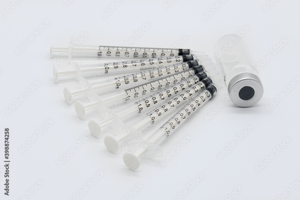 Seven Medical Vaccine Syringes and One Ampule on a white background