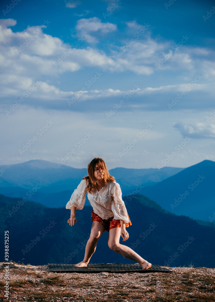 Portrait of a fit, young hip hop dancer while dancing in red skirt on mountain Portrait of a fit, young hip hop dancer while dancing in red skirt on mountain