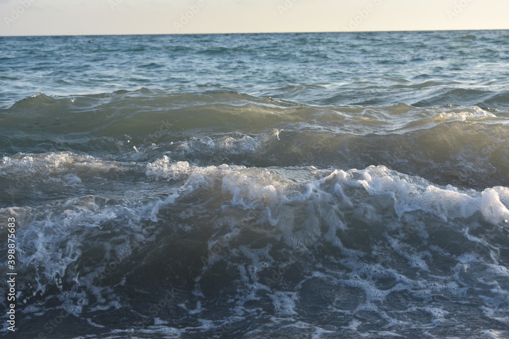 Fototapeta premium waves on the sea and yellow sky