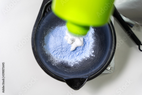 Hairdresser calorist mixes ingredients for hair coloring. hair dyeing process photo