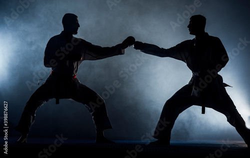 Young man is practicing martial arts in sport gym