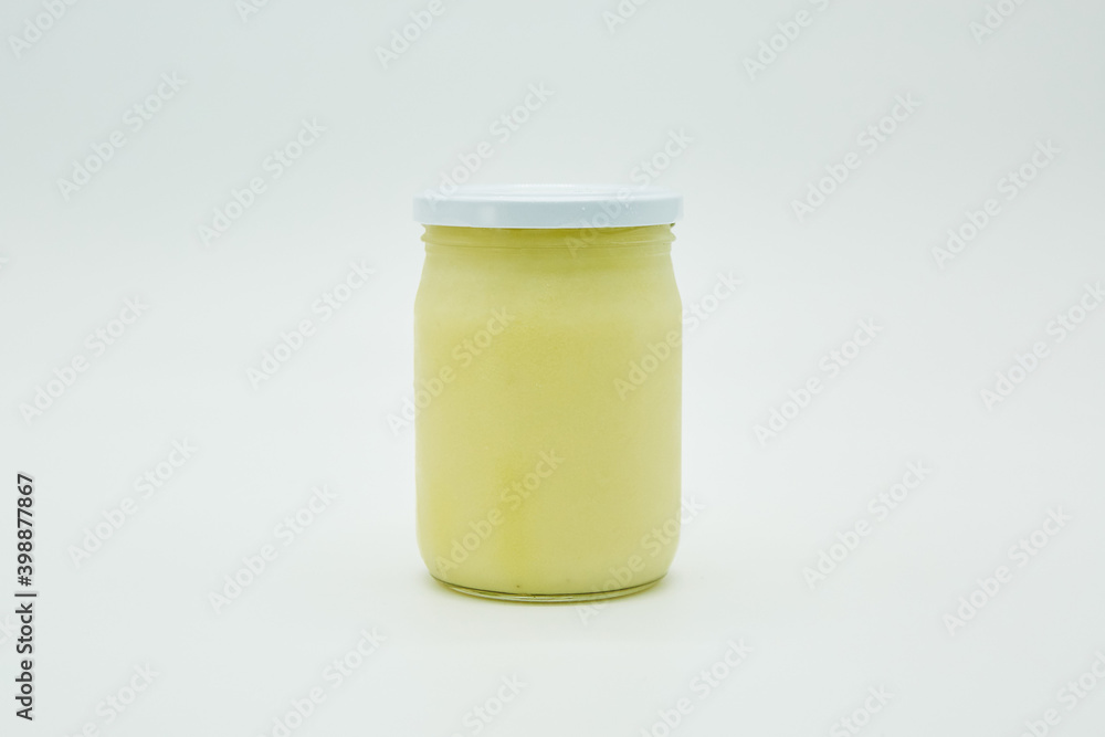Canned white sauce, ghee, ghee, or fat in a glass jar. Home canning. Canned white sauce, ghee, ghee, or fat in a glass jar. Home canning.