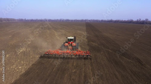 Agriculture. land cultivation. cultivator on a heavy tractor does pre-sowing soil cultivation photo