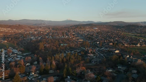 4k Aerial Scenic View Flying Over the City with Majestic Mount as Background photo