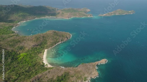 Aerial view coastline with tropical beach, island Limbones, lagoons and coral reefs. Neela cove, Philippines, Luzon. Coast ocean with turquoise water. Tropical landscape in Asia. photo